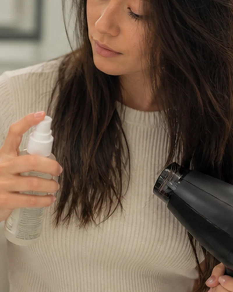 A real-life beauty routine scene illustrating heat protectant